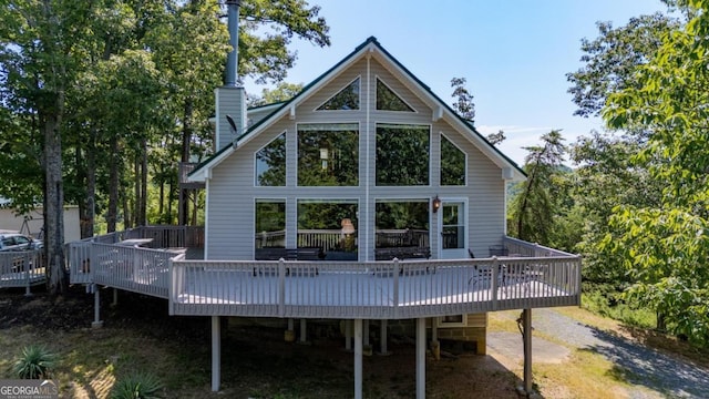 rear view of property featuring a deck