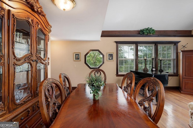 dining space with light hardwood / wood-style floors