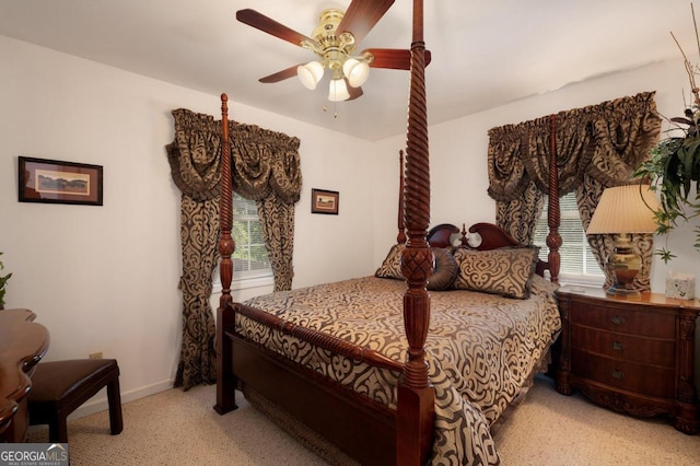bedroom with ceiling fan, light carpet, and baseboards