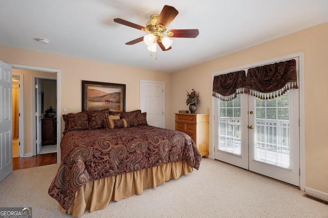 carpeted bedroom with access to exterior, visible vents, a ceiling fan, and french doors
