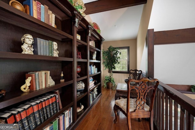 living area featuring dark wood-type flooring and vaulted ceiling