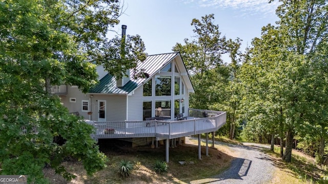 rear view of property featuring a deck