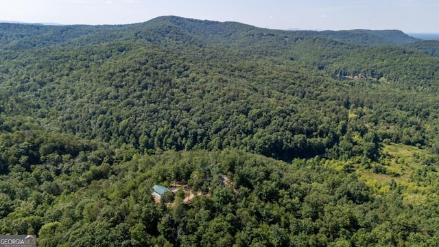 aerial view with a wooded view and a mountain view