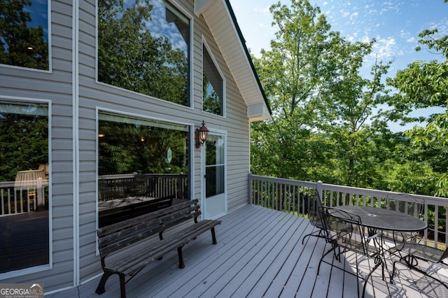 wooden deck featuring outdoor dining space