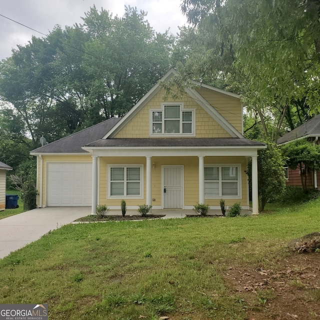 view of front of house with a garage, a front yard, and a porch