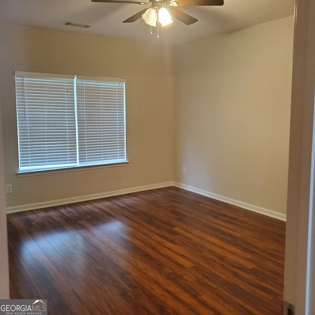 spare room with ceiling fan and dark hardwood / wood-style flooring