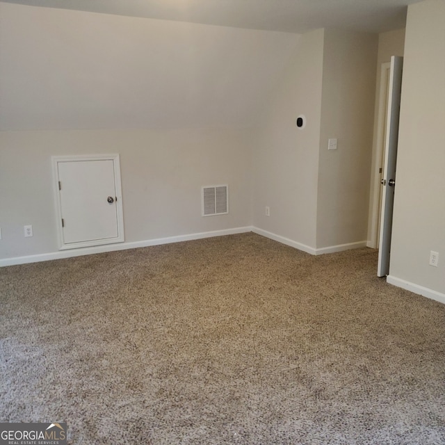 bonus room featuring lofted ceiling and carpet floors