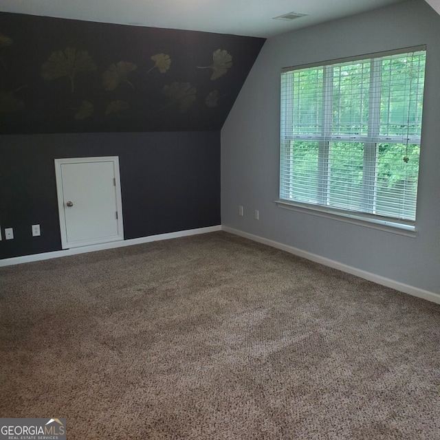 bonus room featuring lofted ceiling and carpet flooring