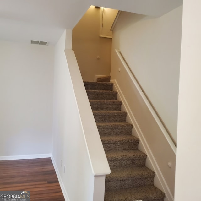 stairway with hardwood / wood-style flooring