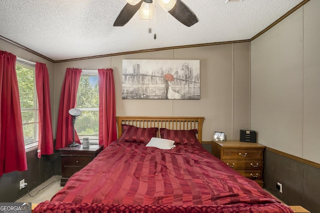 bedroom with ceiling fan, crown molding, vaulted ceiling, and a textured ceiling