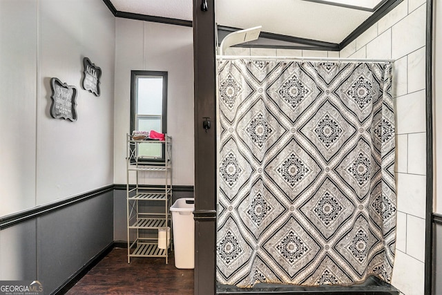 bathroom featuring a shower with curtain, crown molding, and wood-type flooring