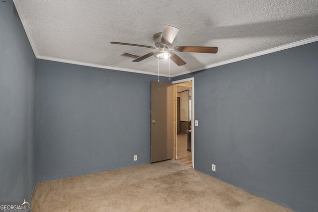 carpeted empty room featuring crown molding, a textured ceiling, and ceiling fan