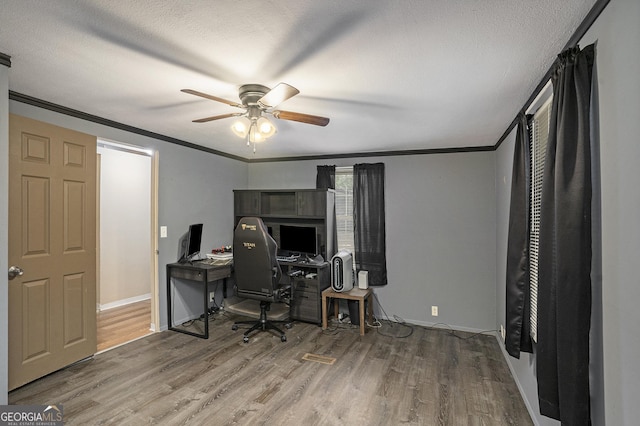 office space with ceiling fan, crown molding, wood-type flooring, and a textured ceiling