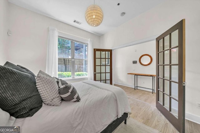 bedroom featuring light hardwood / wood-style flooring and french doors