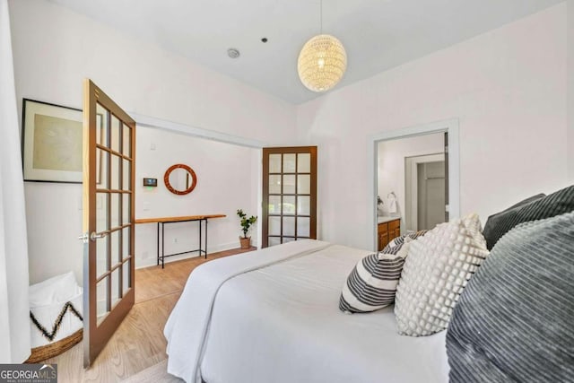 bedroom with light hardwood / wood-style flooring and french doors