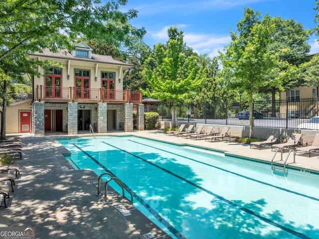 view of swimming pool with an outdoor structure and a patio