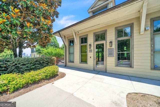 view of exterior entry featuring a patio