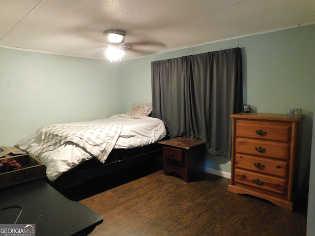 bedroom featuring ceiling fan and dark wood-type flooring