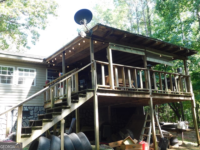 rear view of property with a wooden deck