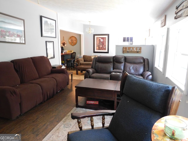 living room featuring dark hardwood / wood-style floors and an inviting chandelier