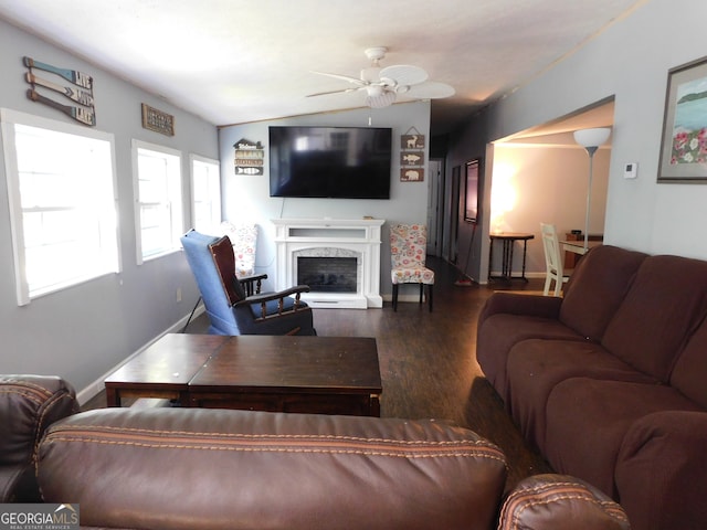 living room featuring a premium fireplace, lofted ceiling, ceiling fan, and hardwood / wood-style floors