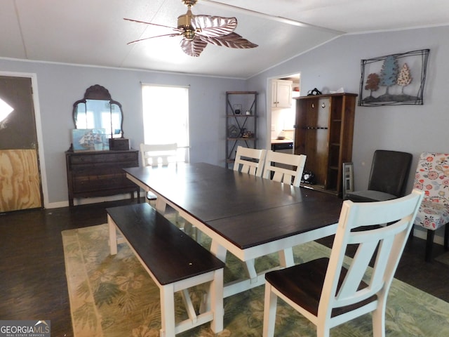 dining room with ceiling fan, vaulted ceiling, and hardwood / wood-style flooring