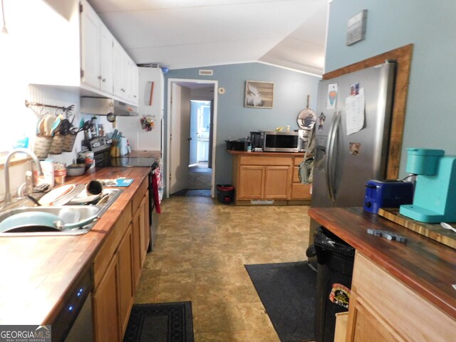 kitchen featuring tile flooring, stainless steel appliances, wood counters, sink, and lofted ceiling