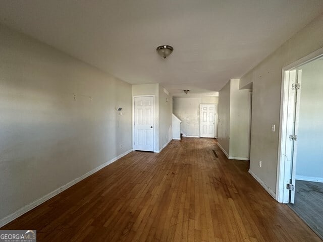 corridor with hardwood / wood-style floors