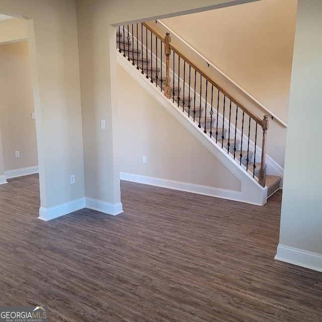 interior space featuring baseboards and wood finished floors