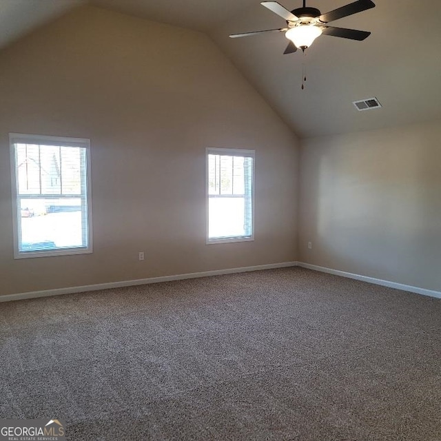 spare room with visible vents, a ceiling fan, carpet flooring, high vaulted ceiling, and baseboards