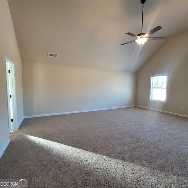 empty room with baseboards, visible vents, a ceiling fan, carpet floors, and high vaulted ceiling