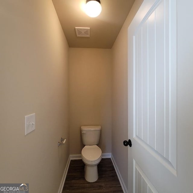 bathroom featuring hardwood / wood-style floors and toilet