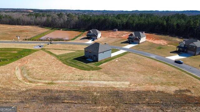 aerial view featuring a rural view and a wooded view