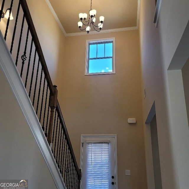 interior space with an inviting chandelier and ornamental molding