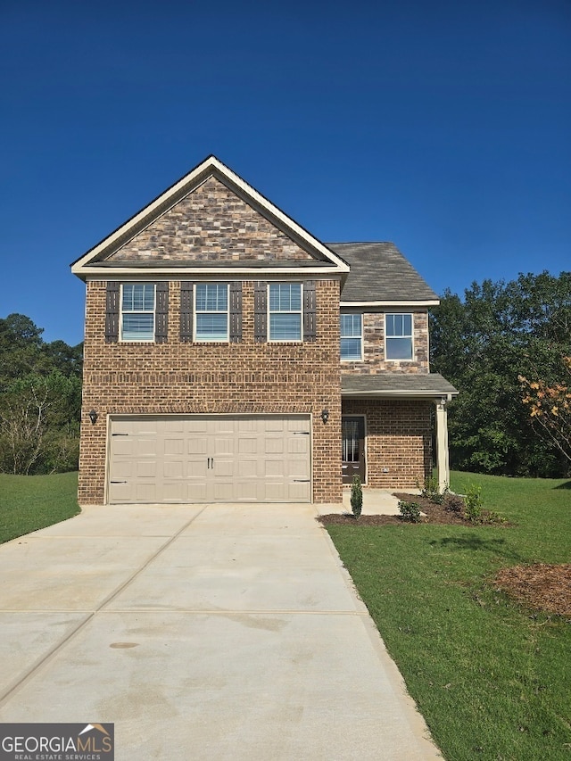 view of front of house with a front yard and a garage