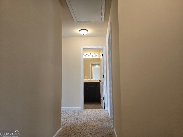 hall featuring light colored carpet