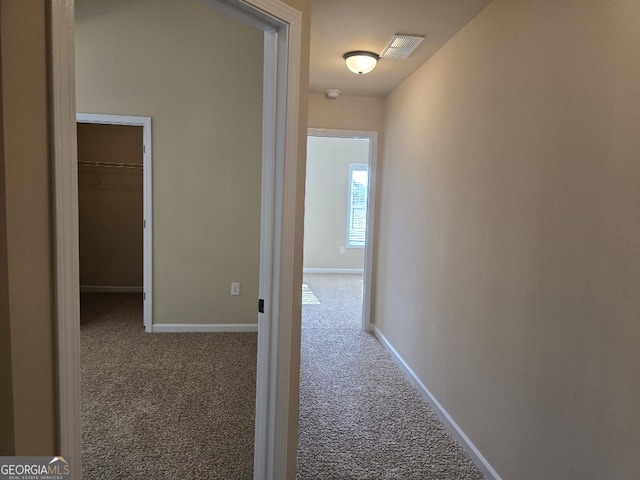 hall featuring carpet flooring