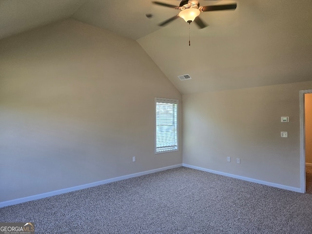 empty room featuring carpet and lofted ceiling