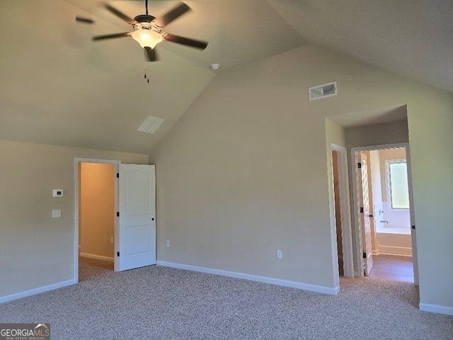 unfurnished bedroom with lofted ceiling, carpet flooring, ceiling fan, and ensuite bathroom