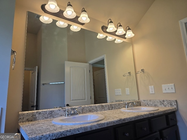 bathroom featuring vaulted ceiling and vanity