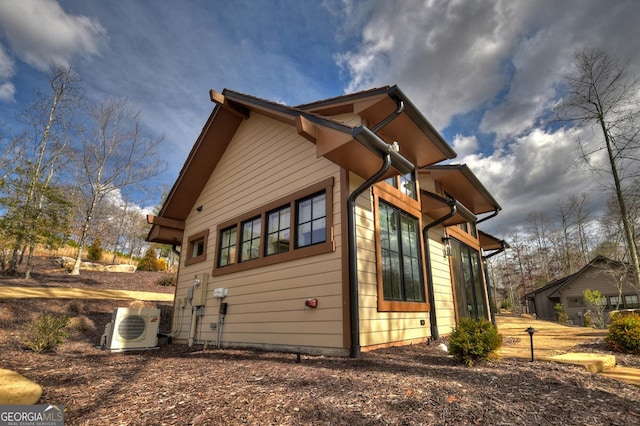 view of side of home featuring ac unit