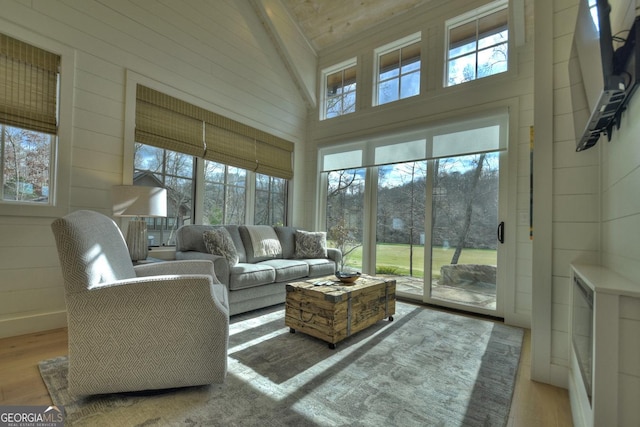 sunroom / solarium featuring lofted ceiling