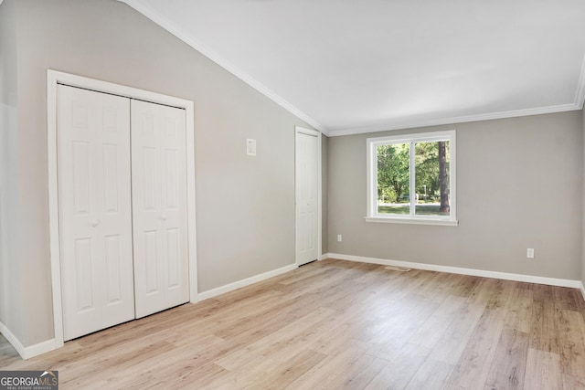 unfurnished bedroom featuring light hardwood / wood-style floors and vaulted ceiling