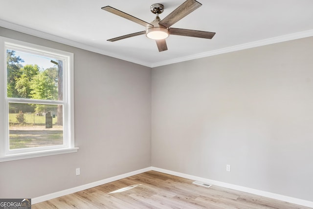 empty room with ceiling fan, light wood-type flooring, and crown molding