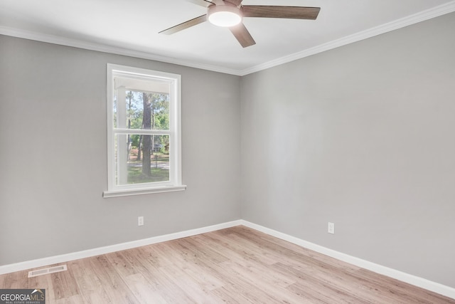 empty room featuring ceiling fan, light hardwood / wood-style floors, and ornamental molding