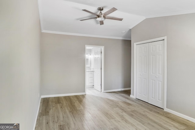 unfurnished bedroom featuring light hardwood / wood-style flooring, ensuite bath, ceiling fan, ornamental molding, and a closet