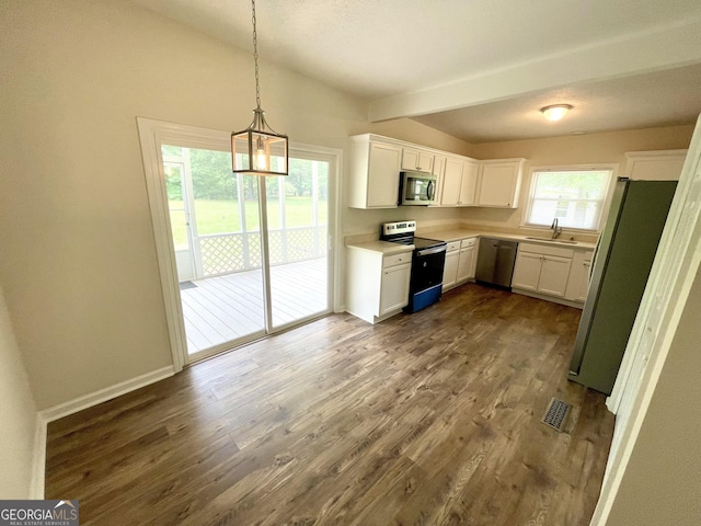 kitchen with dark hardwood / wood-style flooring, stainless steel appliances, sink, decorative light fixtures, and white cabinets