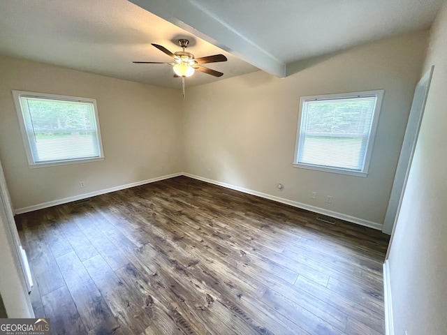 spare room featuring beam ceiling, ceiling fan, and dark hardwood / wood-style flooring