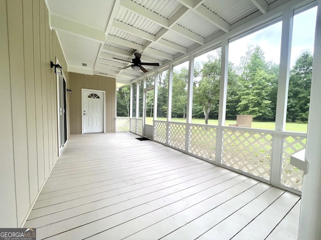 unfurnished sunroom featuring ceiling fan