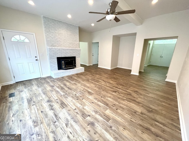 unfurnished living room featuring vaulted ceiling with beams, ceiling fan, and hardwood / wood-style floors